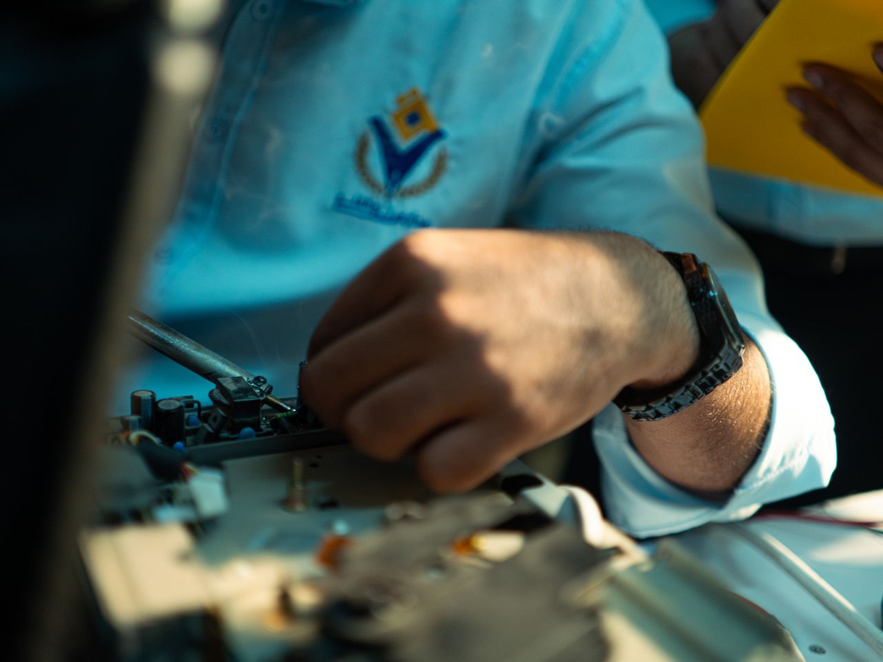 A detailed close-up of a technician working on machinery, highlighting skill and precision.